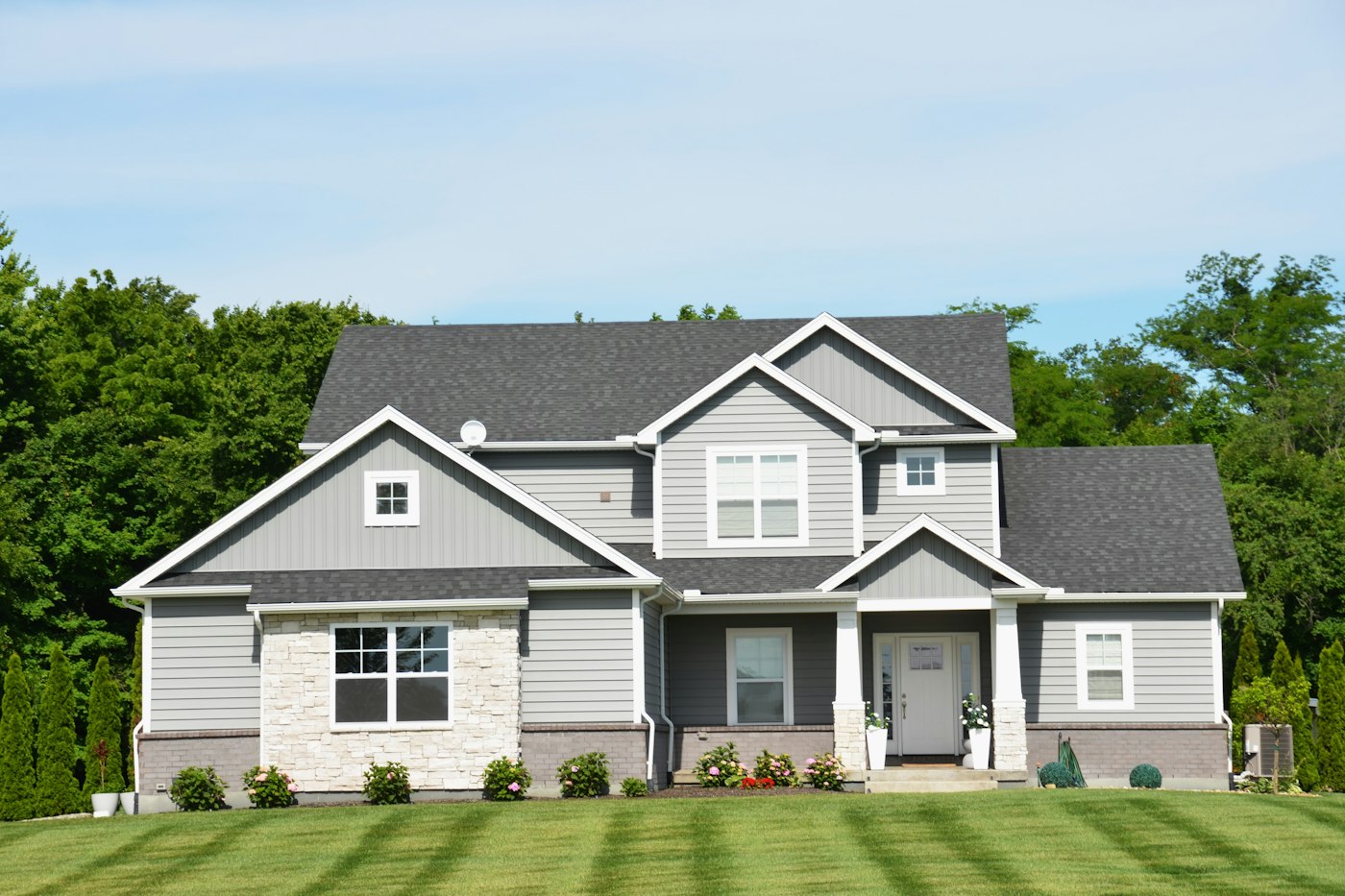 Modern gray house with a simple green lawn